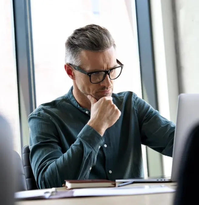 Thinking in front of laptop section image
